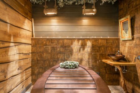 Modern luxury spa room with ambient lighting and comfortable seating representing high-end wellness spaces