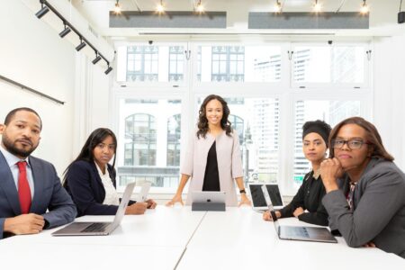 Professional business meeting with executives around conference table