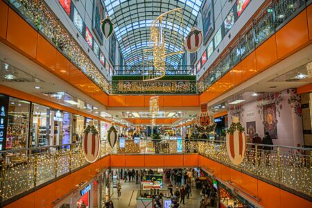 Modern shopping mall interior with multiple levels and wide corridors perfect for fashion runway shows