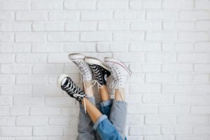 Clean white orthopedic sneakers on neutral background showing modern design and comfort features