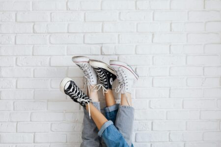 Clean white orthopedic sneakers on neutral background showing modern design and comfort features