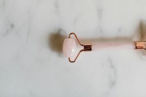 Various skincare tools arranged on clean surface showing beauty tool variety