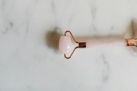 Various skincare tools arranged on clean surface showing beauty tool variety