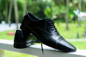 Professional leather dress shoes arranged on wooden surface showing classic business footwear styles