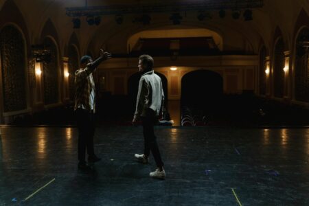 Bright stage lights illuminating a theater interior with dramatic lighting
