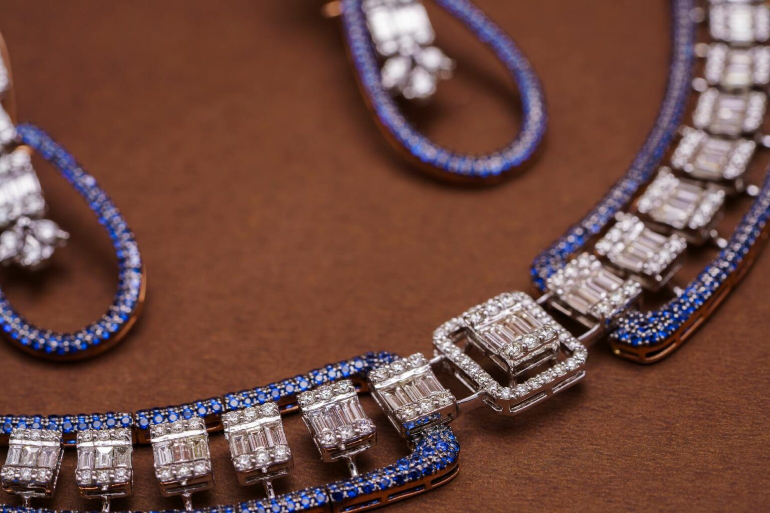 Close-up of elegant vintage jewelry pieces displayed on dark velvet surface