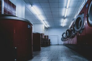 Interior view of a modern laundromat with washing machines and bright lighting