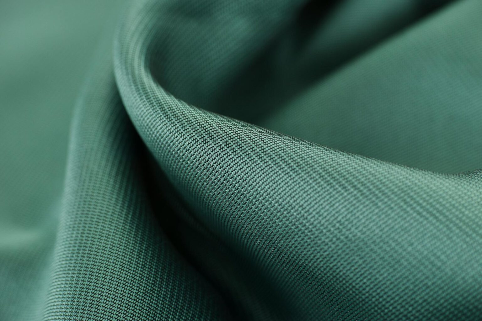 Close-up view of various textile fabrics showing different weaves and fiber textures