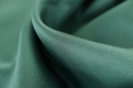 Close-up view of various textile fabrics showing different weaves and fiber textures