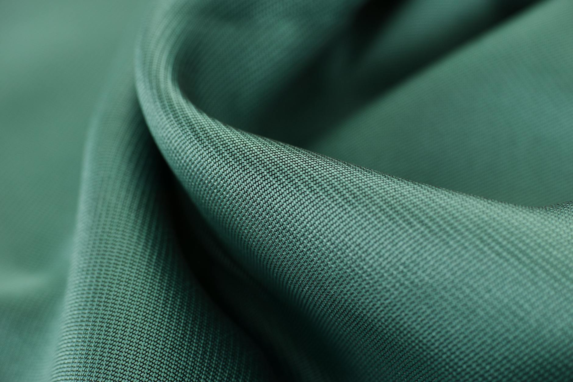Close-up view of various textile fabrics showing different weaves and fiber textures