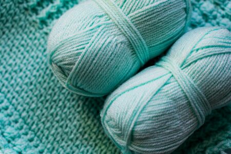 Colorful yarn skeins arranged for crafting, representing the materials used in handmade crochet cardigans