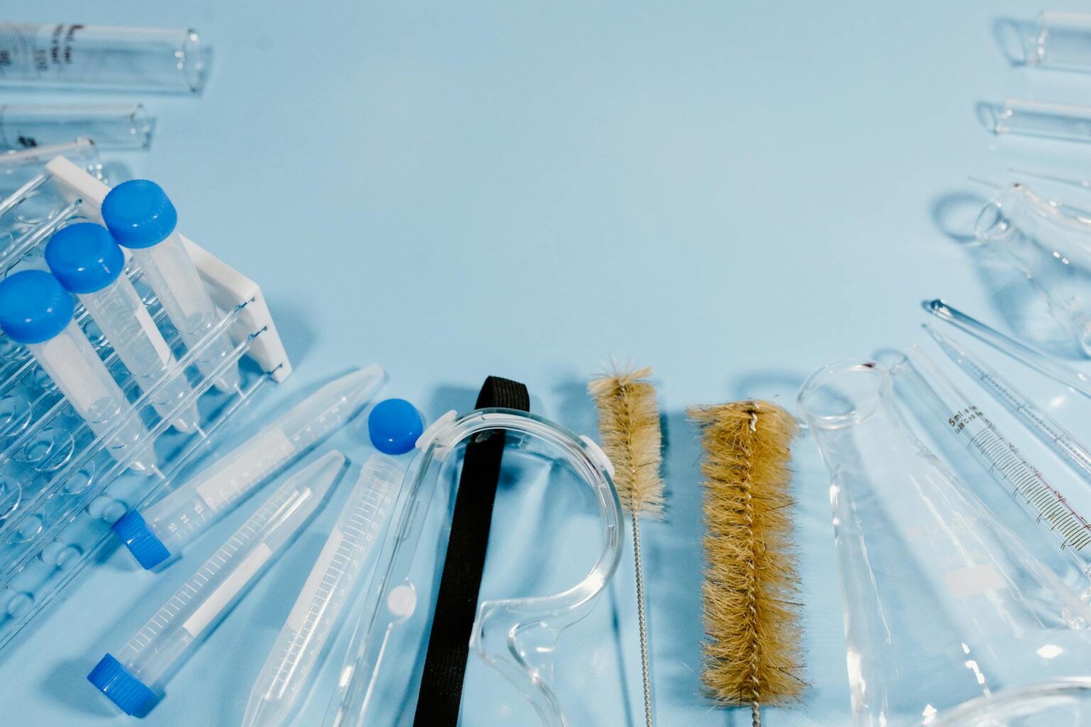 Clean medical laboratory with testing equipment and sample vials on white countertop