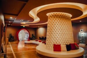 Elegant ice hotel interior with translucent walls and artistic lighting creating a crystalline fashion venue atmosphere