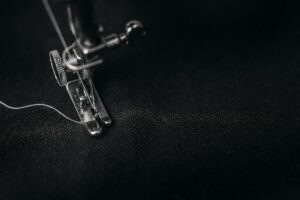 Industrial sewing machine in a textile workshop setting