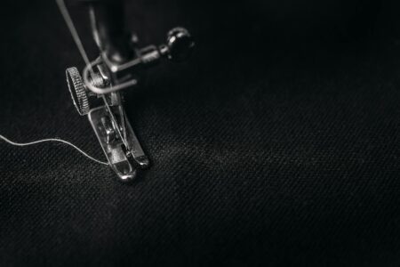 Industrial sewing machine in a textile workshop setting