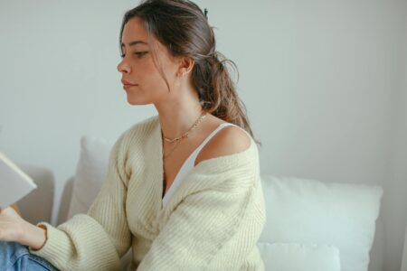 Professional woman wearing oversized cardigan in modern office setting
