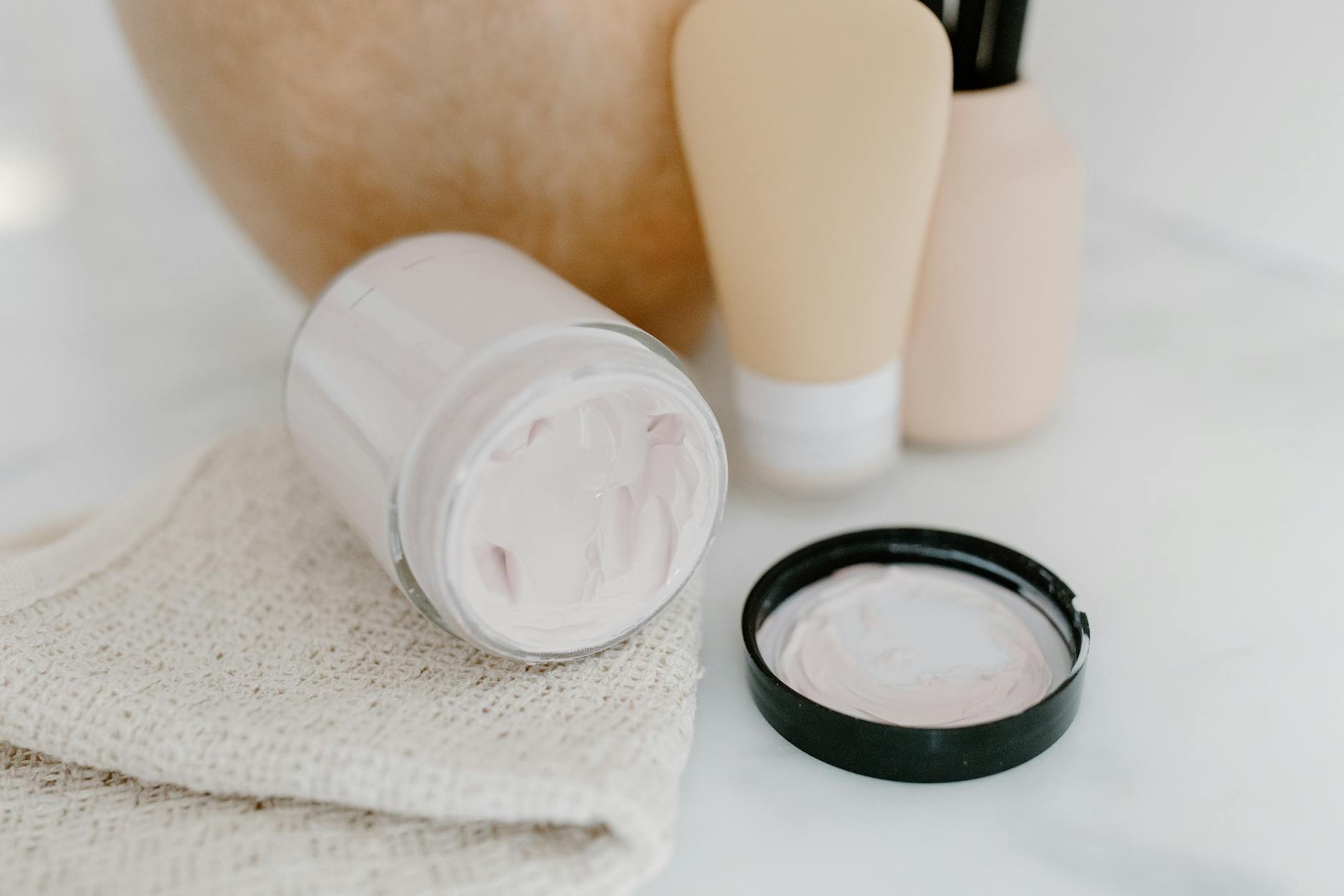 Professional skincare products arranged on a clean white surface for beauty treatment preparation