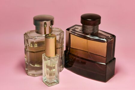 Elegant glass perfume bottles arranged on white surface showing luxury fragrance presentation