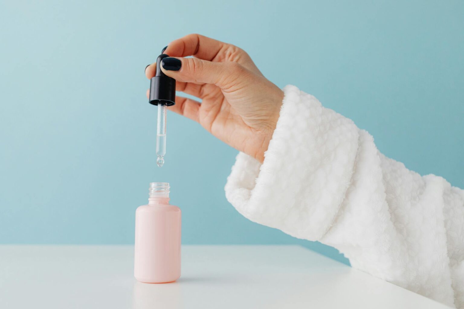 Close-up of skincare serum bottle with dropper, representing peptide-based anti-aging products