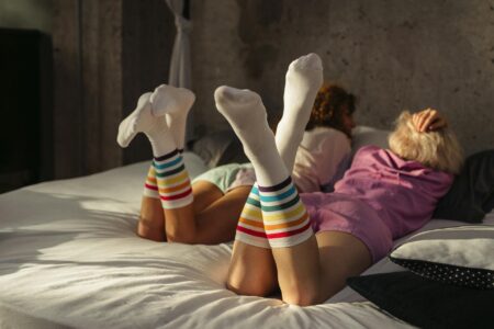 Display of various colorful compression socks showing different patterns and designs