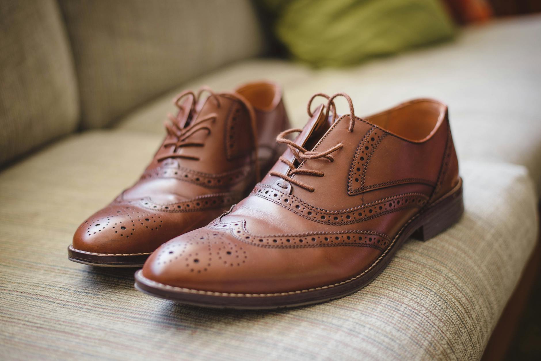 Close-up of elegant leather loafers on wet pavement showing water-resistant properties