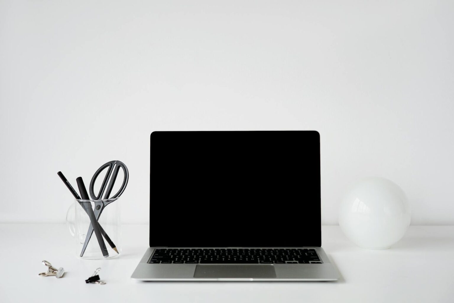 Person organizing digital files on laptop computer with clean workspace