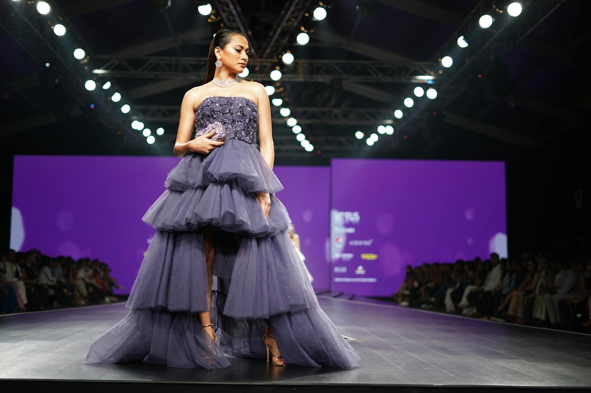 Fashion models walking on runway during designer show