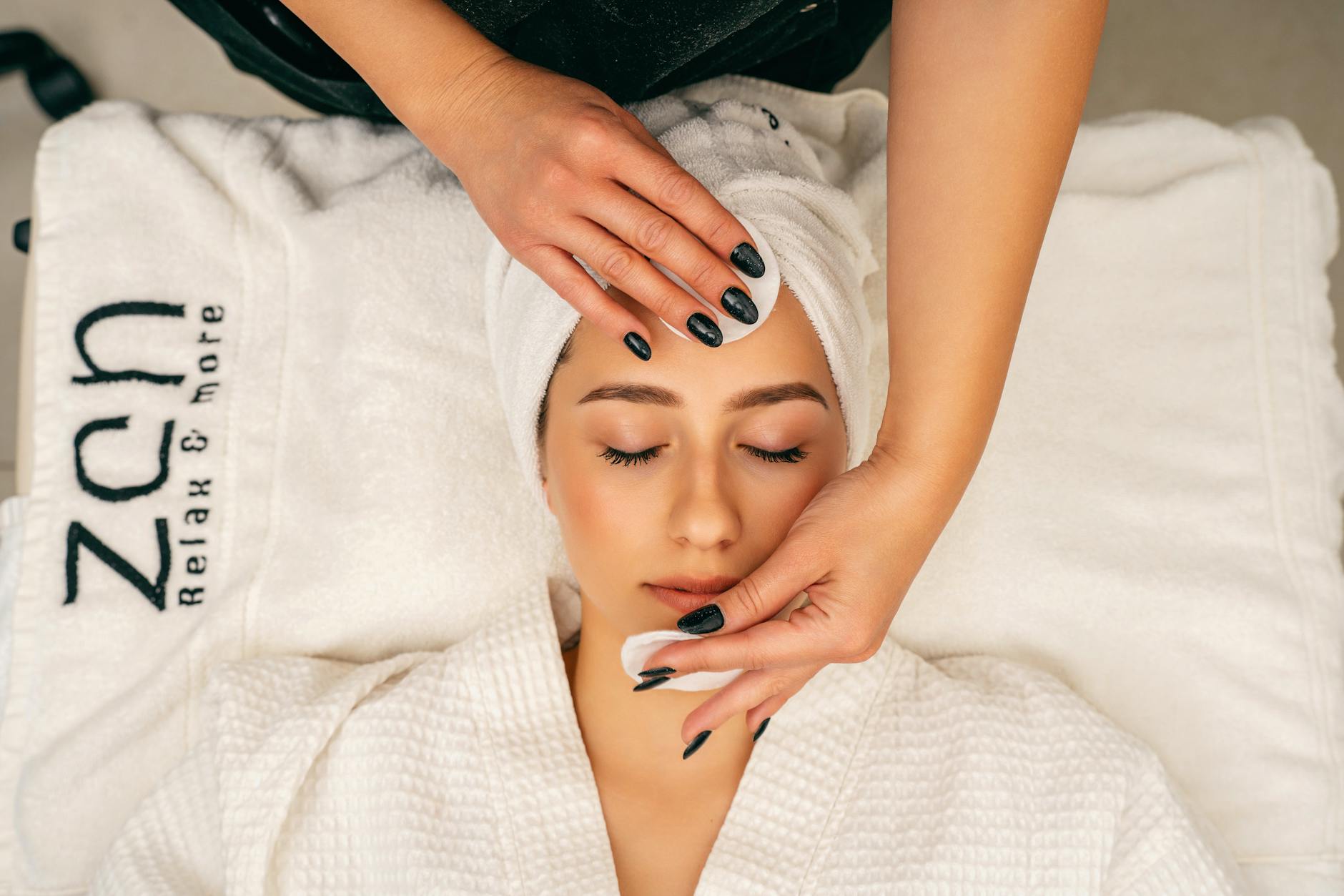 Professional aesthetician performing facial treatment in modern spa setting