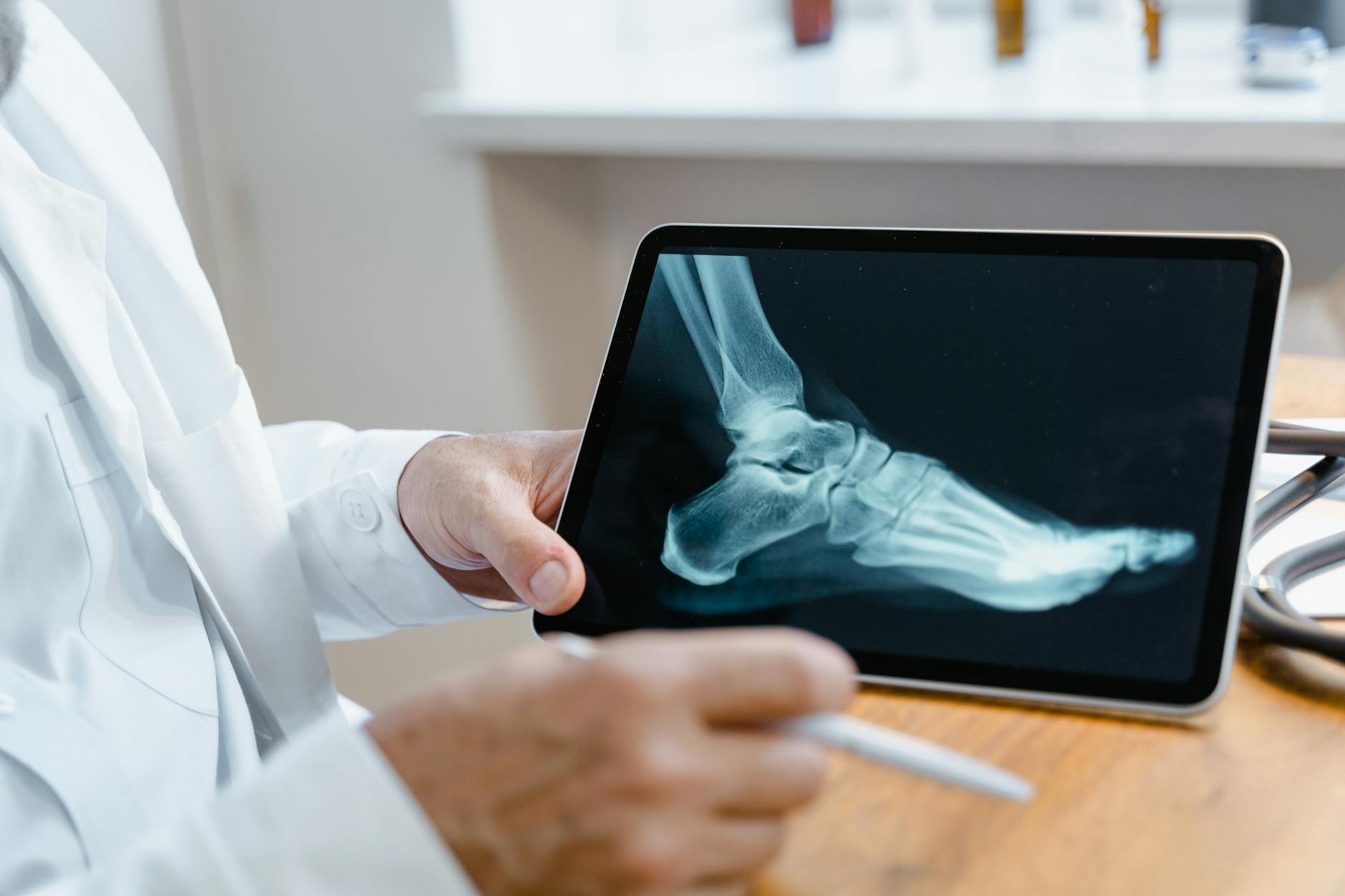 Medical professional examining patient's foot during podiatric consultation