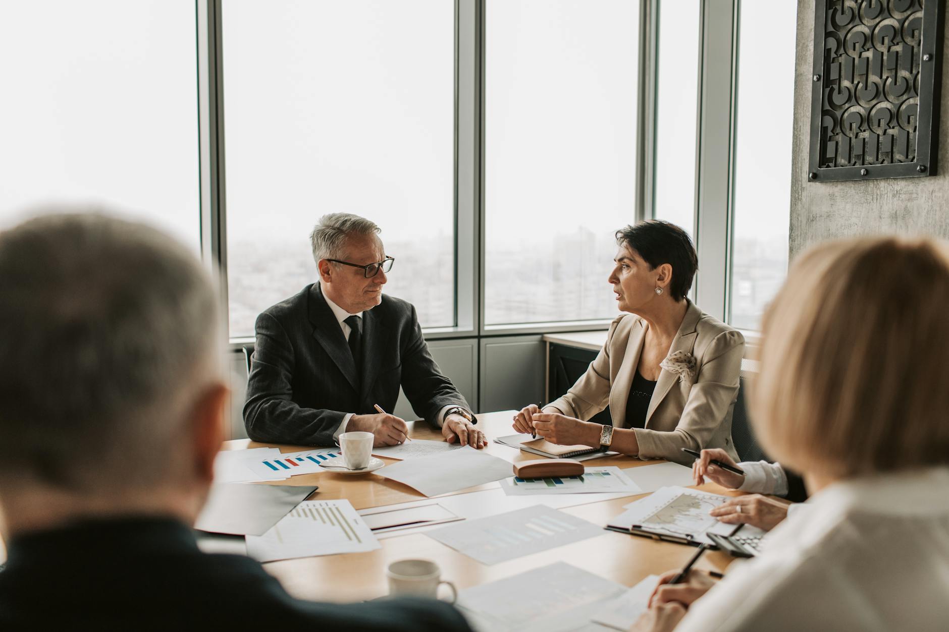 Professional business meeting with executives in modern conference room