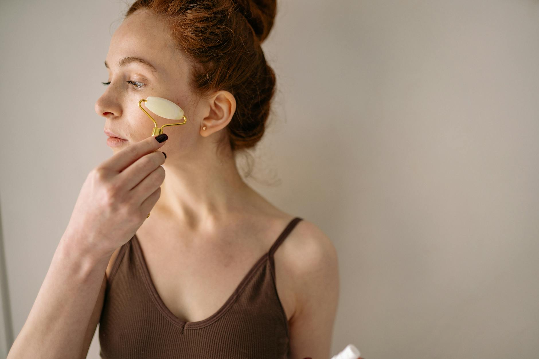 Woman receiving facial massage treatment demonstrating proper technique and pressure