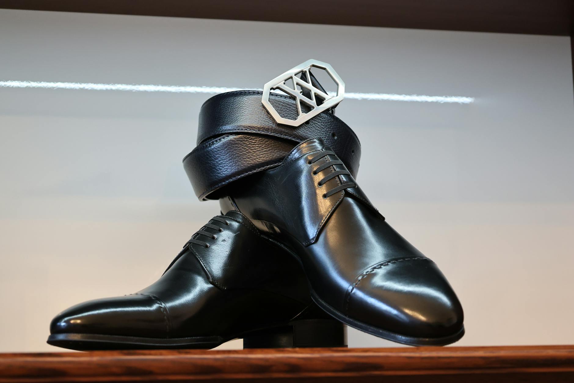 High-end designer sneakers displayed in retail setting, showcasing premium footwear craftsmanship