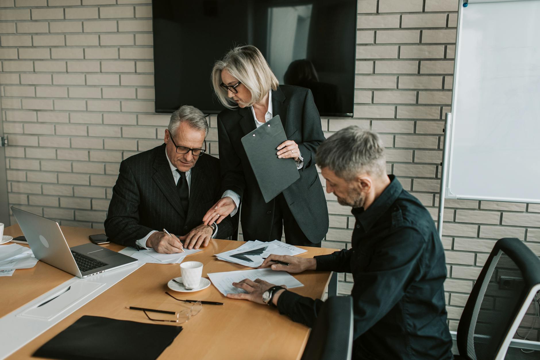Professional business meeting in modern office setting where signature scents enhance personal branding