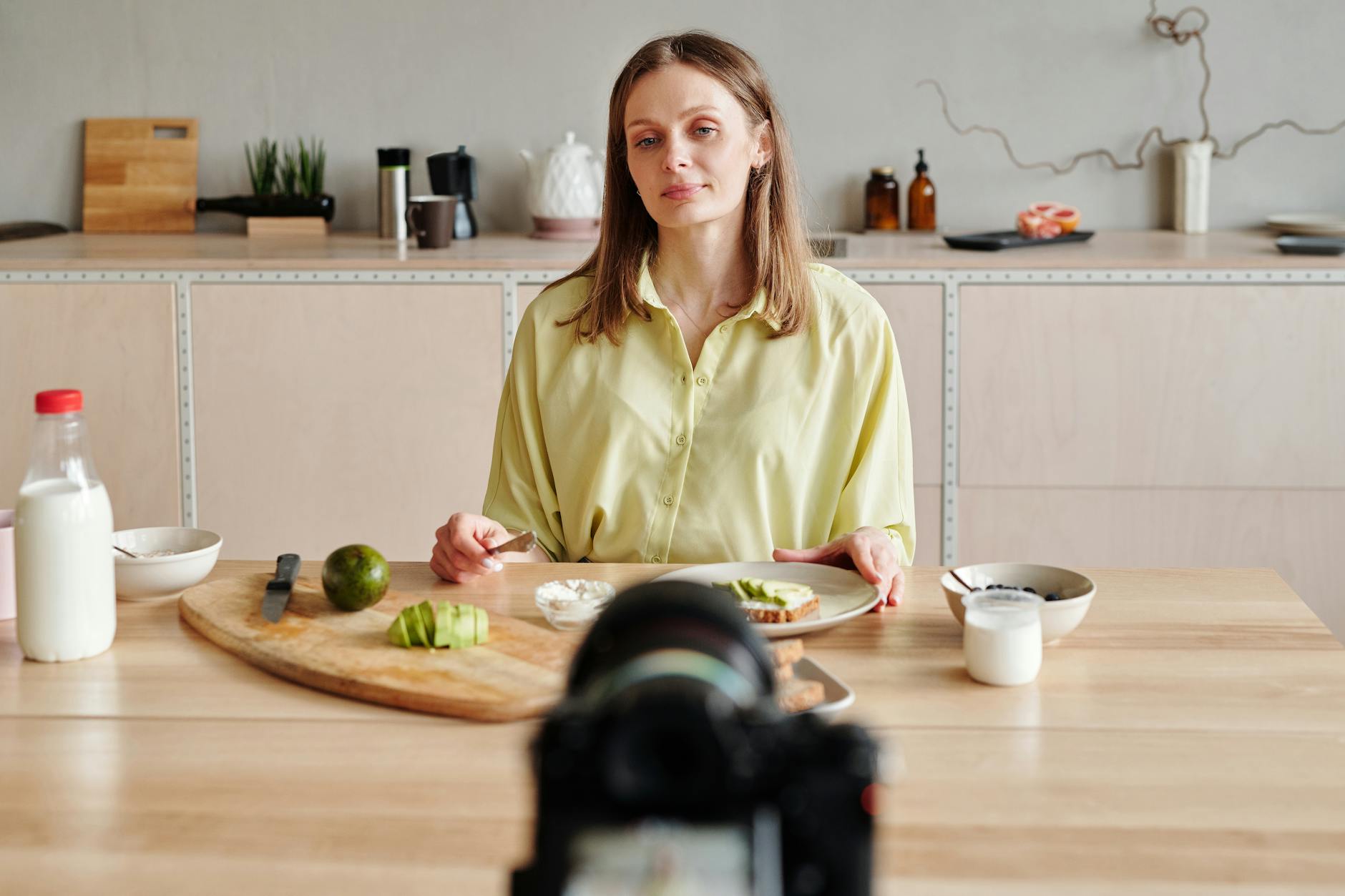 Woman in athletic wear demonstrating wellness products for social media content creation