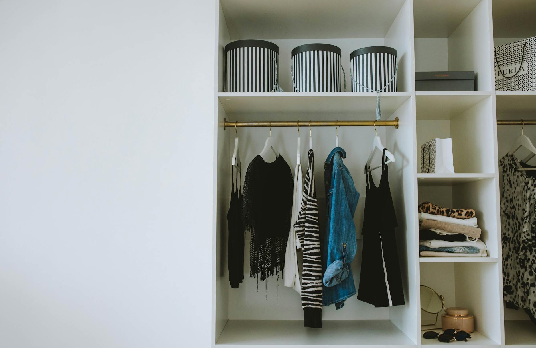 Pristine organized wardrobe displaying high-end designer clothing and shoes
