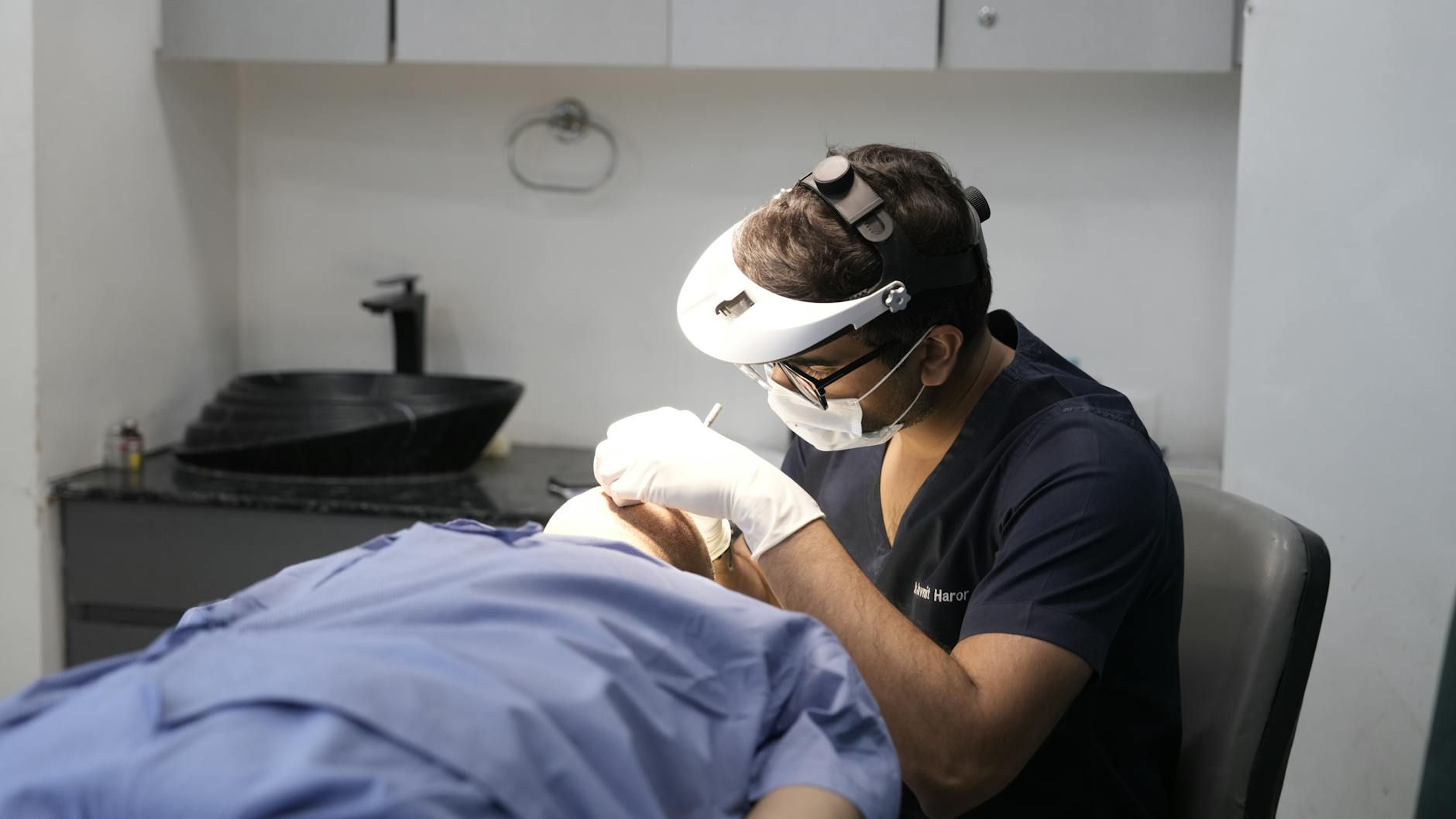 Professional dermatologist in white coat consulting with patient in modern medical office