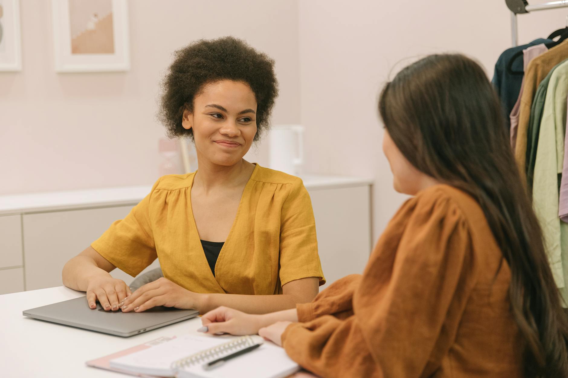 Professional consultation session with clothing and style materials on table