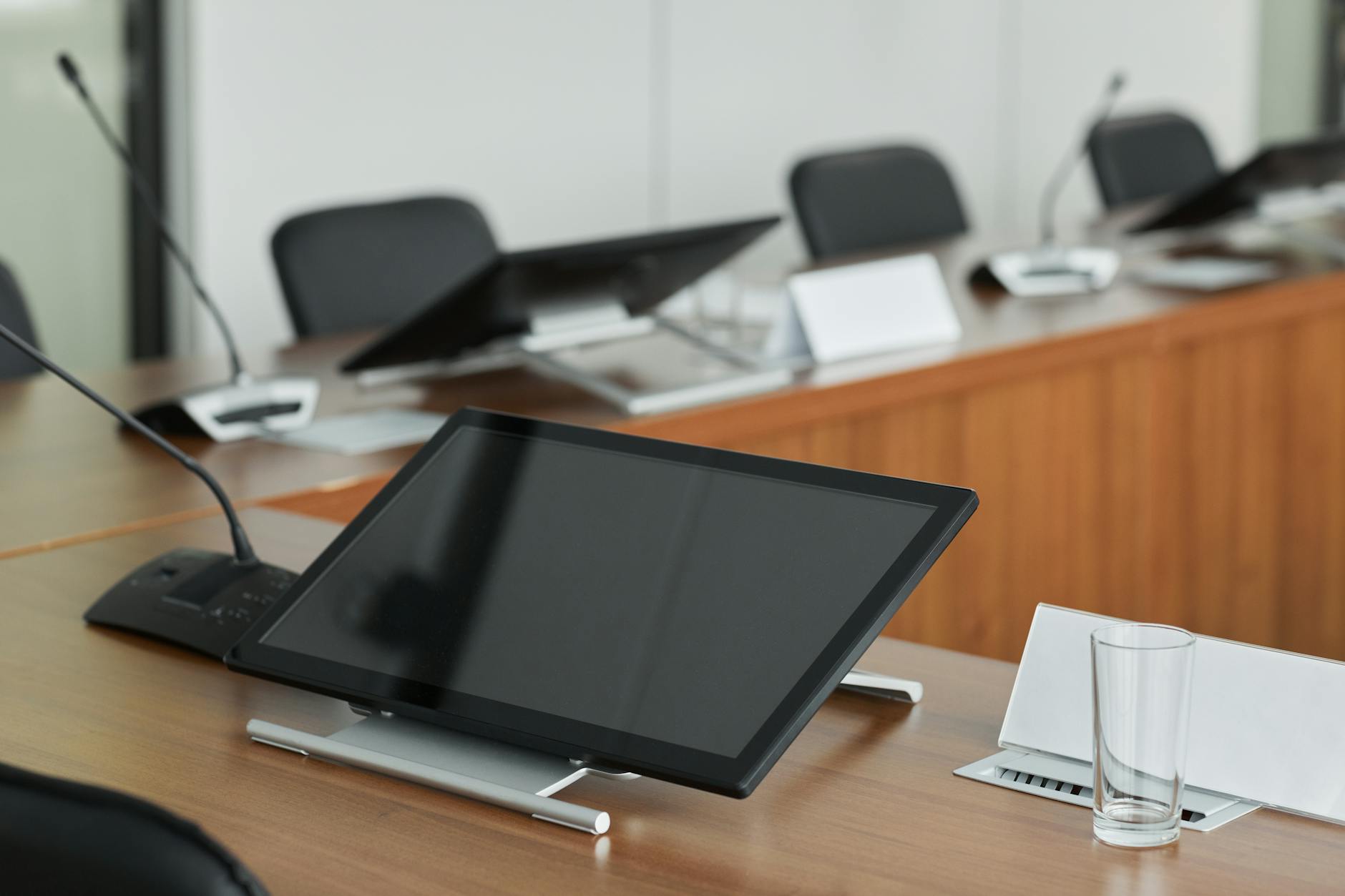 Modern corporate boardroom with executives in professional attire during a business meeting