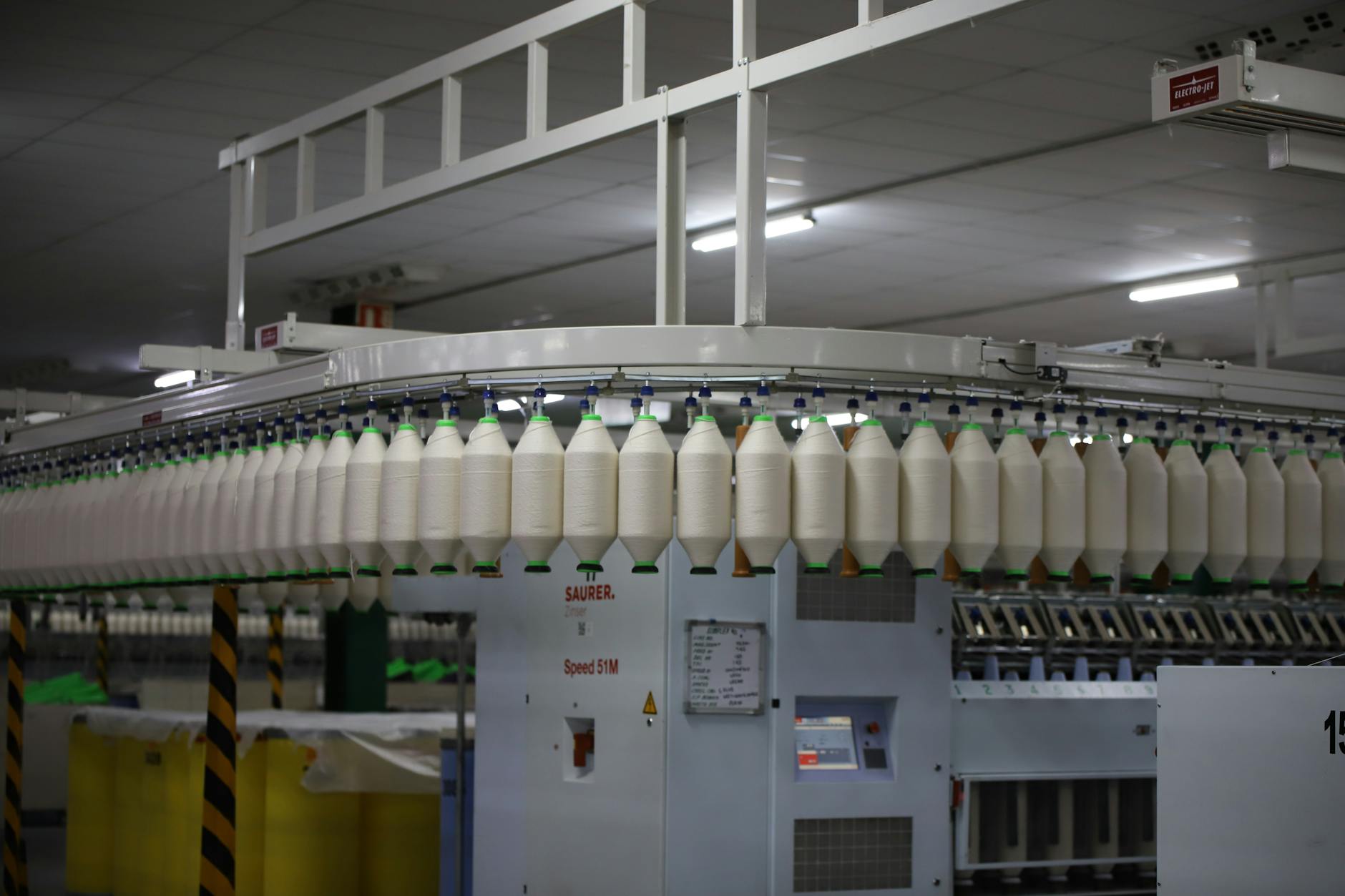 Interior view of a modern textile manufacturing facility with equipment and workstations
