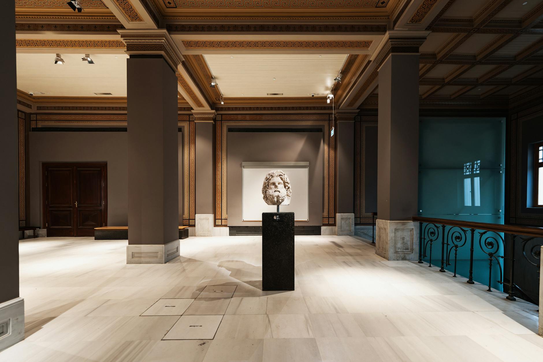 Spacious museum exhibition hall with artwork displays and modern lighting design