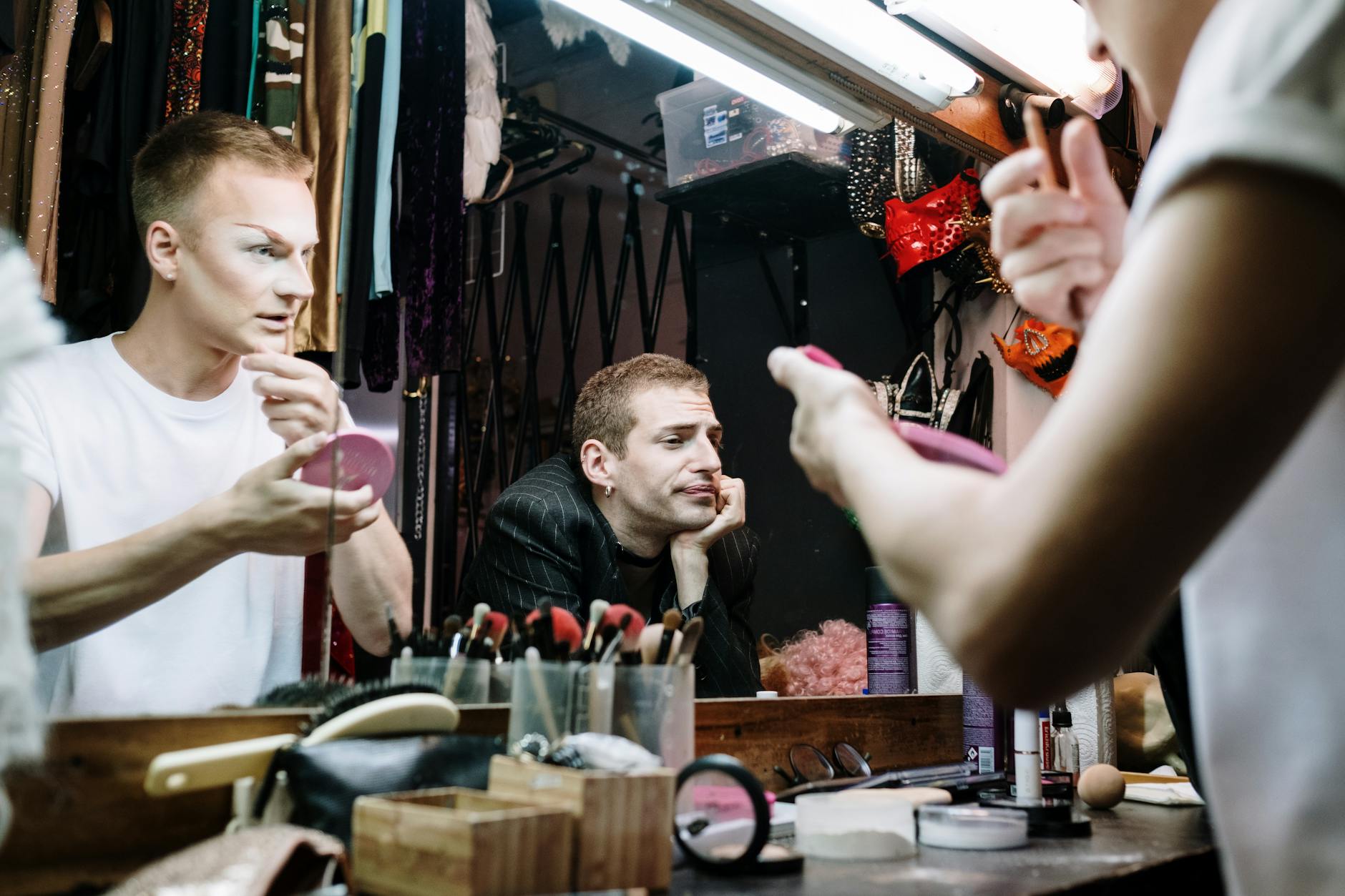 Professional makeup artist applying cosmetics backstage at fashion show