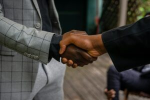 Business professionals shaking hands over partnership agreement