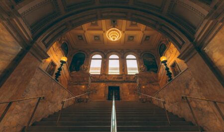 American Money Keeps the Louvre and Versailles Standing Ornate gilded hall inside a historic French palace with chandeliers and painted ceilings