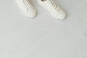 White canvas low-top sneakers on a clean surface