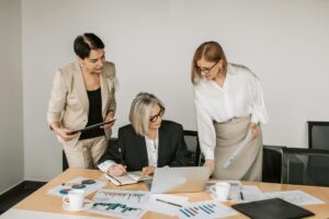 Group of professional women in a modern business setting representing female leadership in the footwear industry