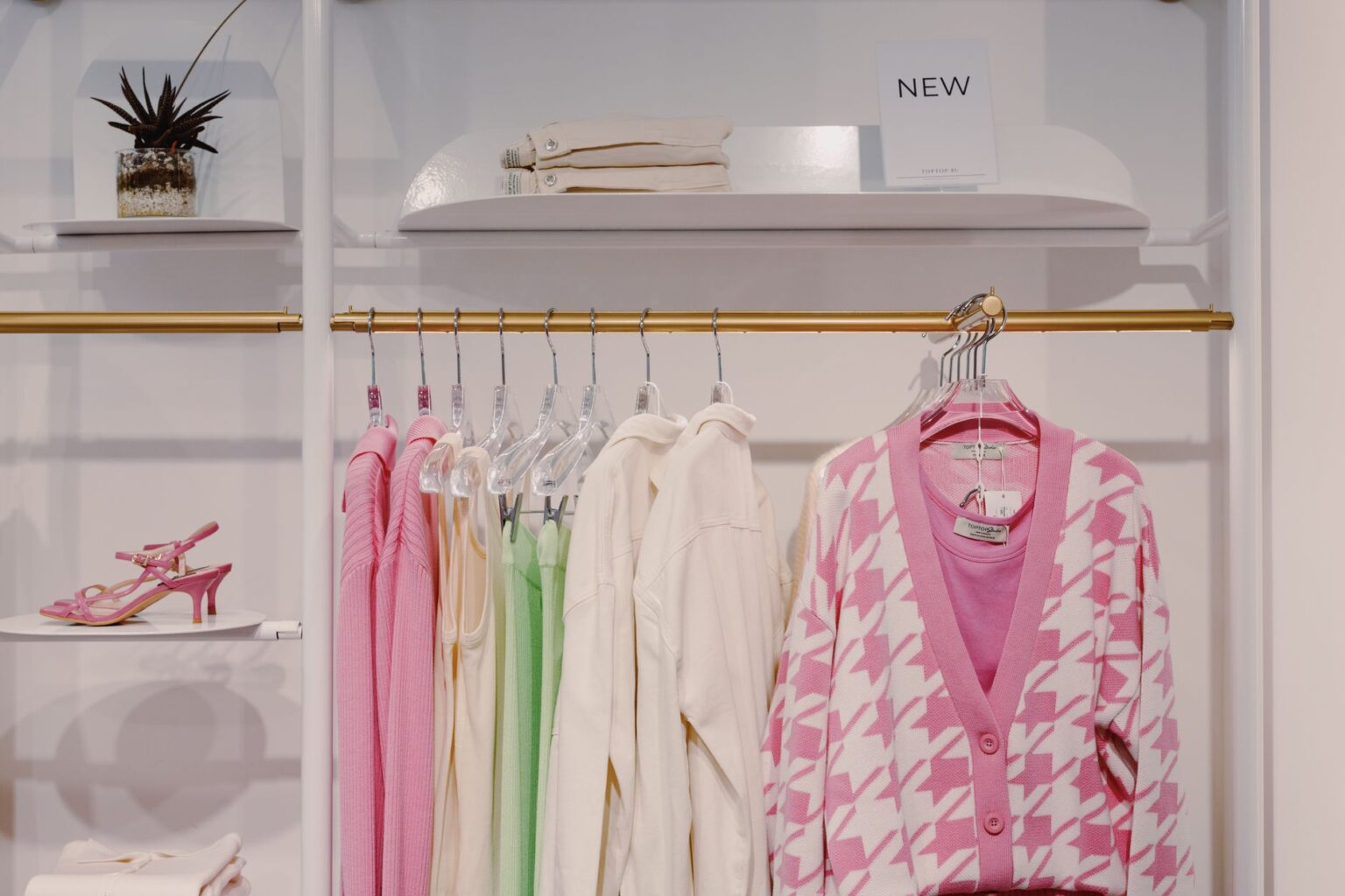 Shoppers browsing a fashion retail store with visible product labels