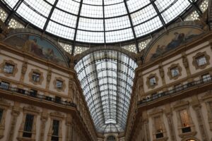 A menswear runway show in Milan with models walking in tailored suits