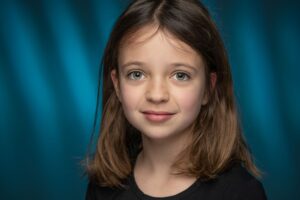 Young actress in dramatic lighting, serious expression