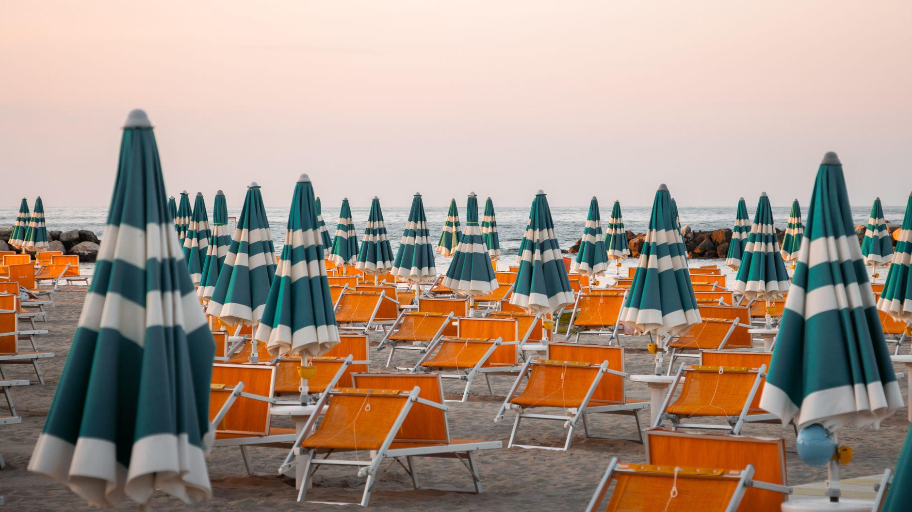 Elegant Italian beach club terrace overlooking the sea on a sunny summer day