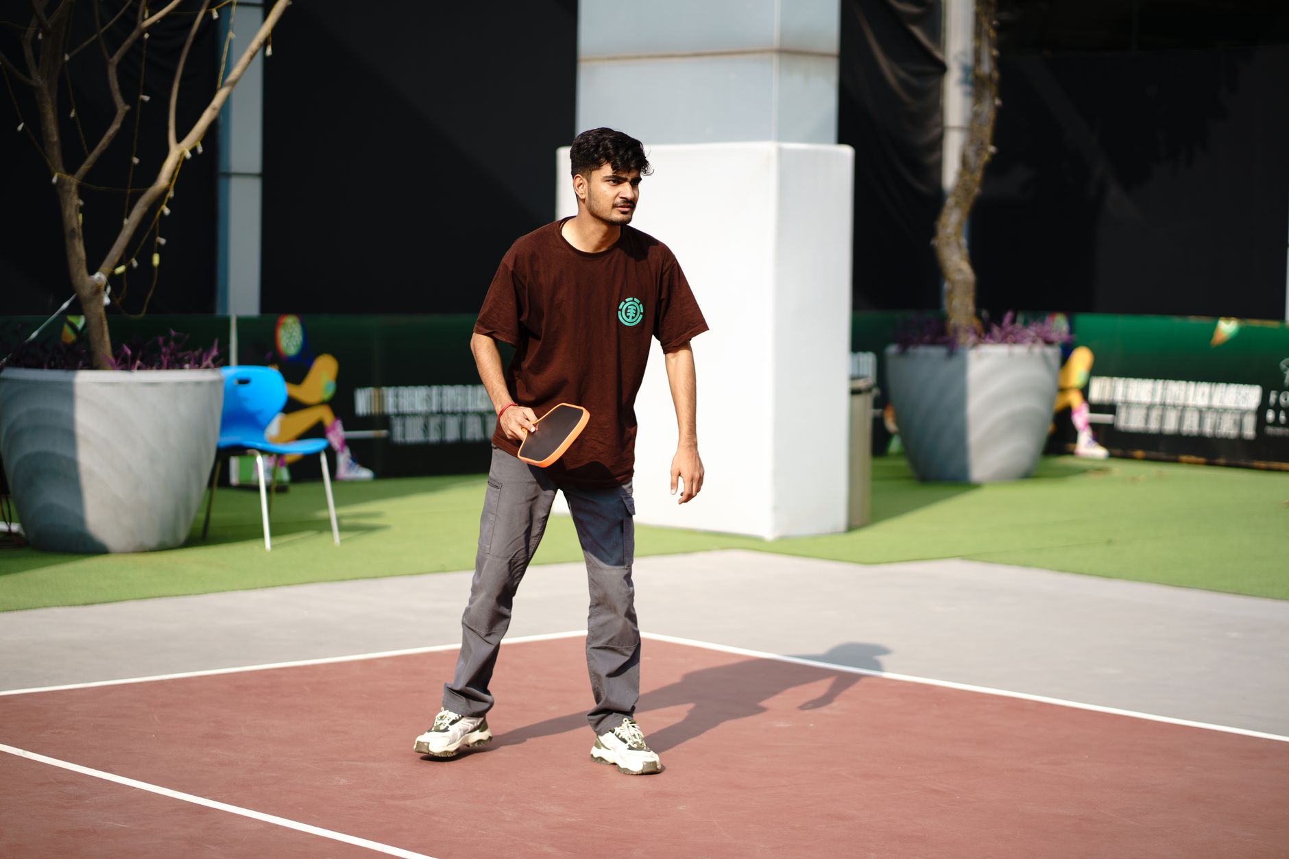Player on a pickleball court mid-movement during a game